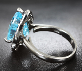 Серебряное кольцо с голубым топазом лазерной огранки 9,2 карата и синими сапфирами