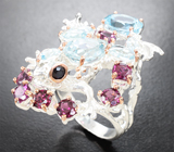 Серебряное кольцо с голубыми топазами, родолитами гранатами и корундами